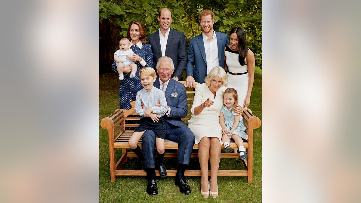 In this handout image provided by Clarence House and taken on Sept. 5, 2018, Britain's Prince Charles poses for an official portrait to mark his 70th Birthday in the gardens of Clarence House, with Camilla, Duchess of Cornwall, Prince William, Kate, Duchess of Cambridge, Prince George, Princess Charlotte, Prince Louis, Prince Harry and Meghan, Duchess of Sussex, in London, England. (Chris Jackson/Pool Photo)