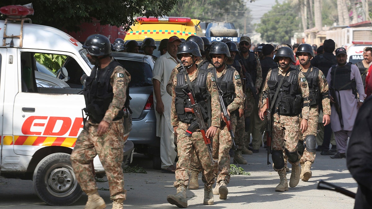 Pakistani security personnel arrive at the Chinese Consulate in Karachi, Pakistan, Friday, Nov. 23, 2018. (AP Photo/Shakil Adil)
