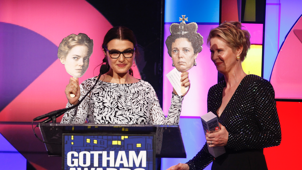 Actress Rachel Weisz, left, holds photos of her co-stars Emma Stone and Olivia Colman from the movie "The Favorite" as she accepts a special honor from Cynthia Nixon, right, at the 28th annual Independent Filmmaker Project's Gotham Awards at Cipriani Wall Street on Monday, Nov. 26, 2018, in New York.