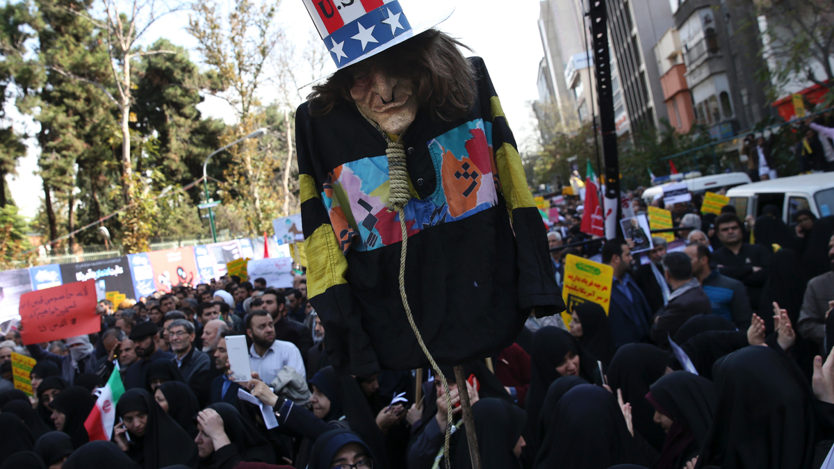 An effigy of U.S. government icon "Uncle Sam" is held up by demonstrators during a rally in front of the former U.S. Embassy in Tehran, Iran, on Sunday,  (AP Photo/Vahid Salemi)