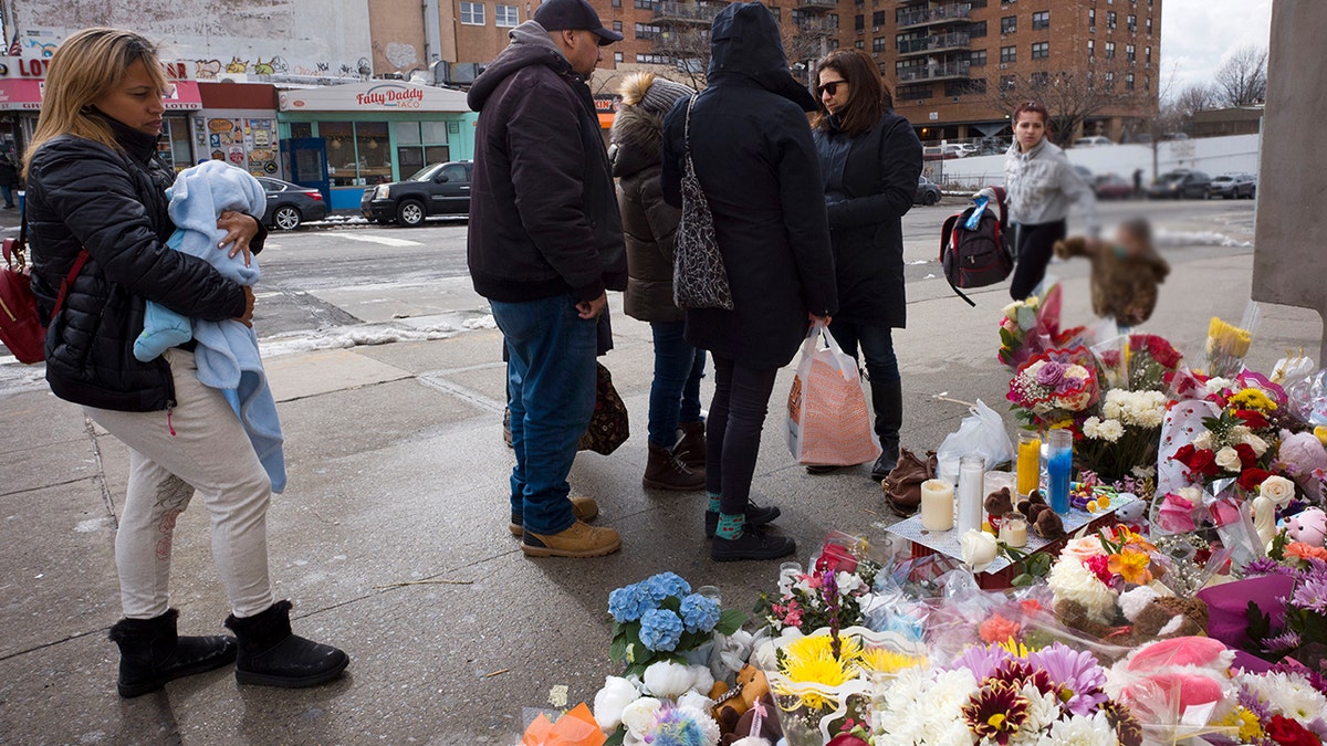 In this March 8, 2018 file photo, people gather at a sidewalk memorial for two children who were killed the previous week when they were struck by a car driven by a woman who likely had a seizure behind the wheel, in the Park Slope neighborhood of the Brooklyn borough of New York. Dorothy Bruns was found dead in her home in Staten Island borough of New York on Tuesday, Nov. 6.