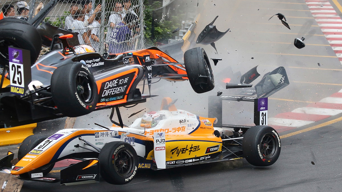 Sophia Floersch of Germany, top, goes over Japanese driver Sho Tsuboi's car while flying off the track at high speed on a tight right-hand bend on lap four.