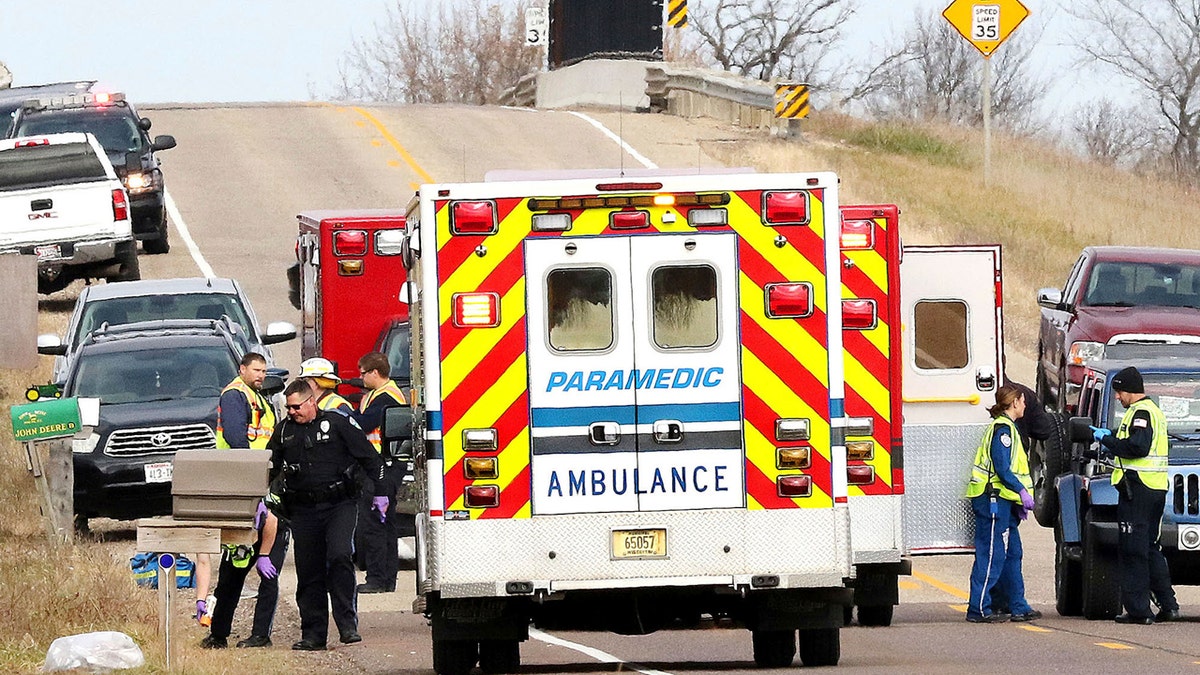 Emergency medical personnel gather at the scene of a hit-and-run accident Saturday, Nov. 3, 2018, in Lake Hallie, Wis., that killed three girls and an adult.