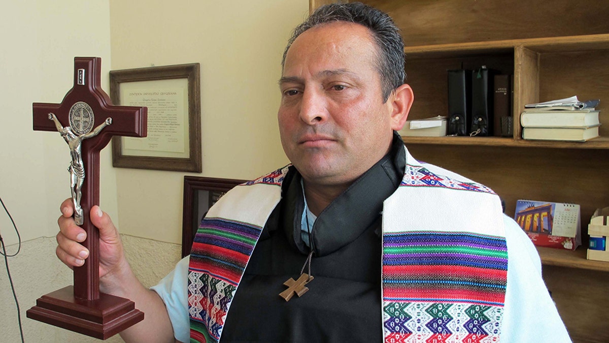 Jan. 16, 2014 - Apatzingan, MICHOACAN, MEX - Father Gregorio Lopez Geronimo models the bulletproof vest that he now uses when he celebrates Mass at the Cathedral in Apatzingan, a small city in Mexico's Michoacan state, Jan. 16, 2014. (Credit Image: © Tim Johnson/TNS/ZUMAPRESS.com)