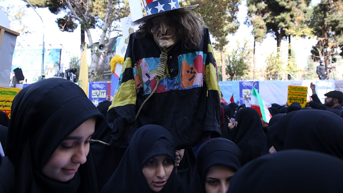 A demonstrator holds an effigy of Uncle Sam during a rally in front of the former U.S. Embassy in Tehran, Iran, on Sunday, marking the 39th anniversary of the seizure of the embassy by militant Iranian students. (AP Photo/Vahid Salemi)