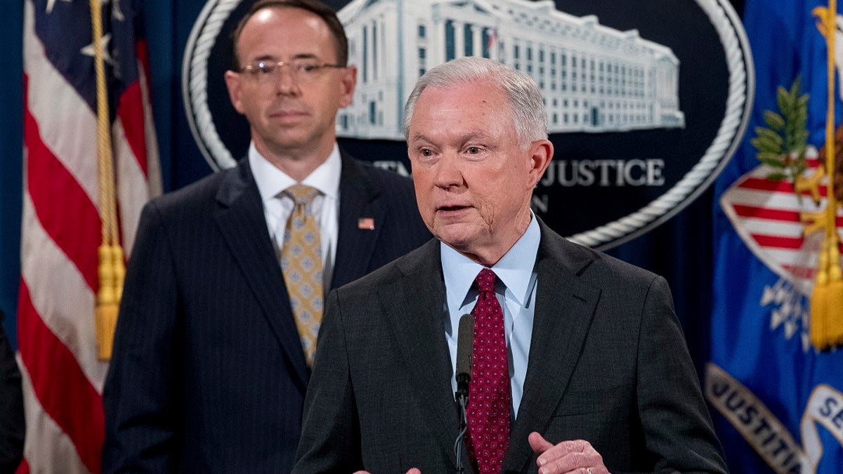 FILE - Attorney General Jeff Sessions accompanied by Deputy Attorney General Rod Rosenstein, speaks at a news conference at the Justice Department in Washington.