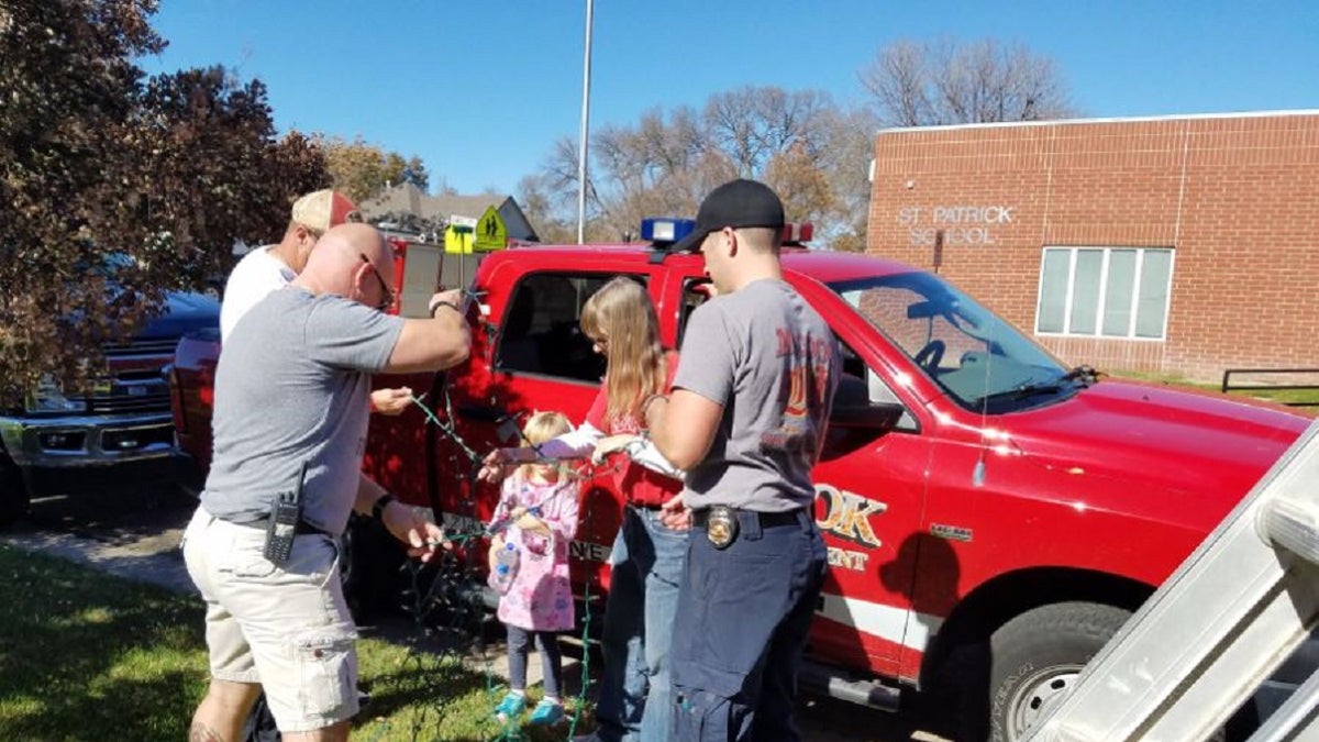 The McCook Fire Department gathered to help the family of Raleigh Haas put up Raleigh's Christmas lights.