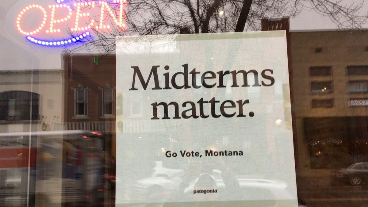 A sign posted on a downtown Bozeman, Mont. coffee shop window reads "Midterms matter. Go Vote, Montana" - it's a Patagonia sign, the outdoor company that's publicly endorsed Tester.