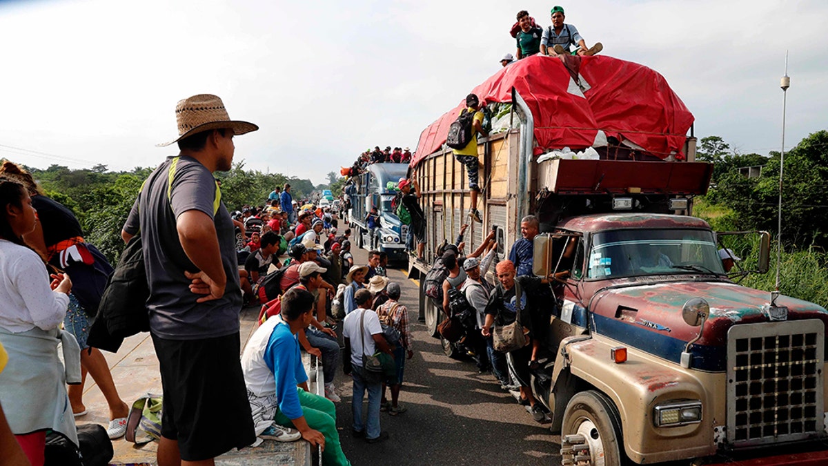 Central American migrants, part of the caravan hoping to reach the U.S. border, get a ride on trucks, in Donaji, Oaxaca state, Mexico, Friday. (AP Photo/Marco Ugarte)