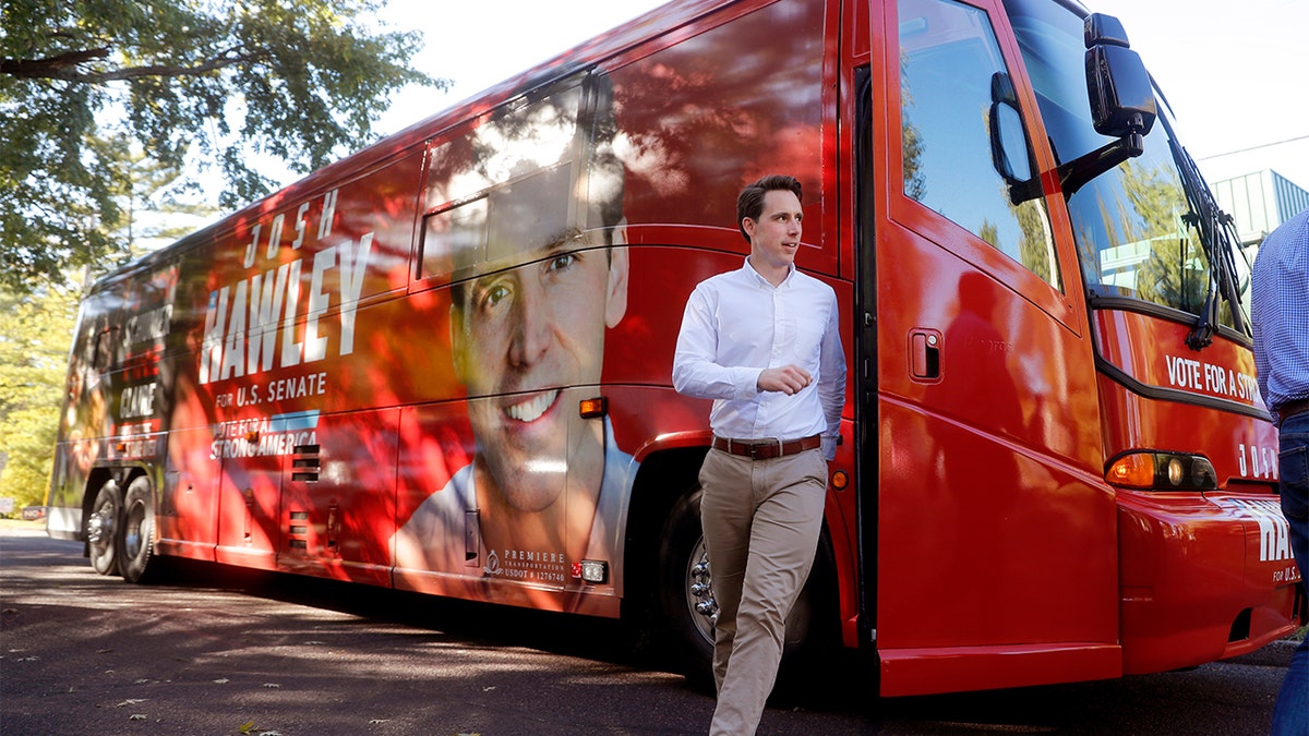 Missouri Attorney General and Republican U.S. Senate candidate Josh Hawley steps off his campaign bus to speak to supporters during a stop Tuesday, Oct. 23, 2018, in Ballwin, Mo. Hawley is seeking to unseat Democratic incumbent Sen. Claire McCaskill. (AP Photo/Jeff Roberson)
