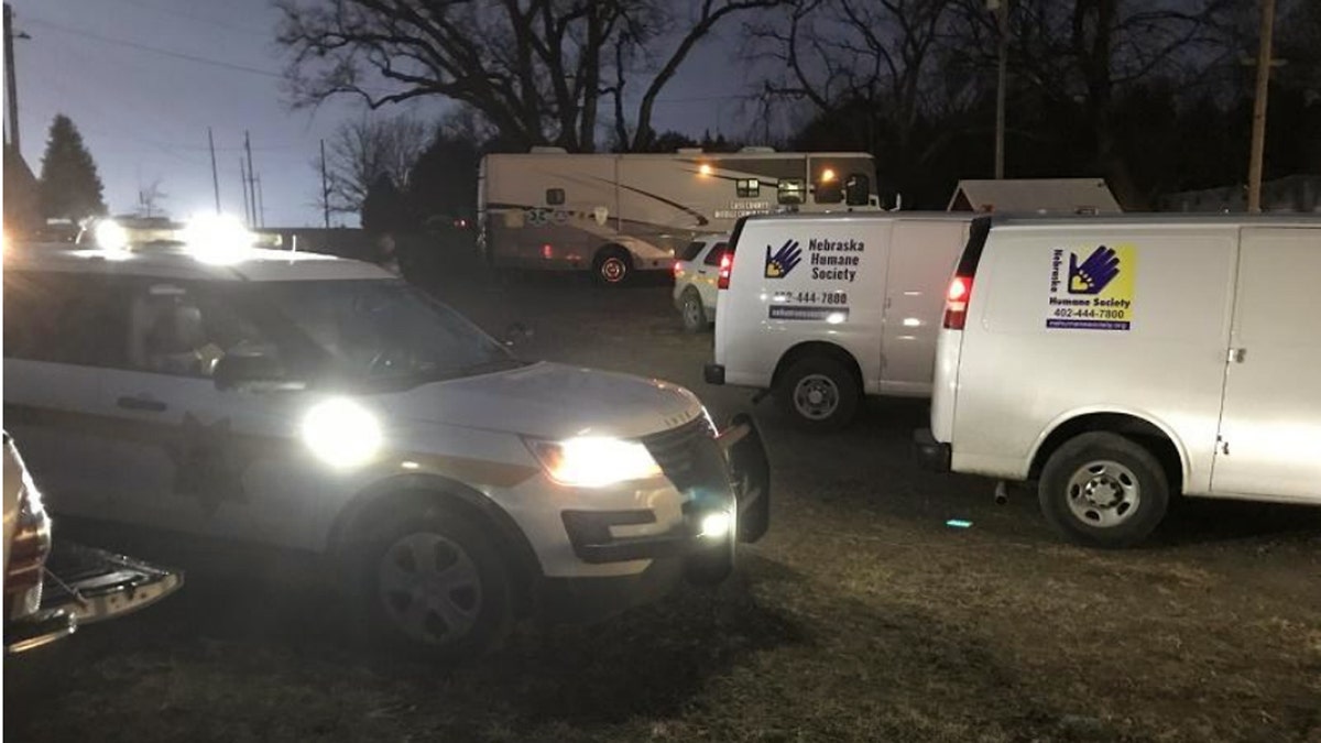Authorities respond to a farm near Louisville, Neb. after receiving a tip about a cockfighting ring Saturday.