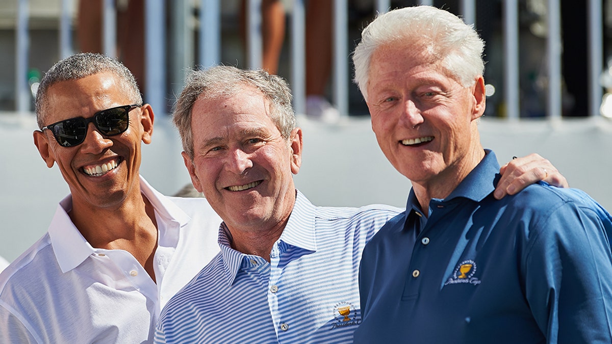 JERSEY CITY, NJ - SEPTEMBER 28: Presidents Obama, G.W. Bush, and Bill Clinton smile while on the first tee during the first round of the Presidents Cup at Liberty National Golf Club on September 28, 2017 in Jersey City, New Jersey. (Photo by Shelley Lipton/Icon Sportswire via Getty Images)