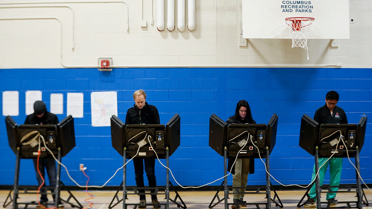 Across the country, voters headed to the polls Tuesday in one of the most high-profile midterm elections in years. (AP Photo/John Minchillo)