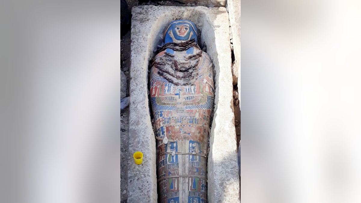 This undated photo released by the Egyptian Ministry of Antiquities on Wednesday, Nov. 28, 2018, shows an ancient mummy covered with a layer of painted cartonnage,