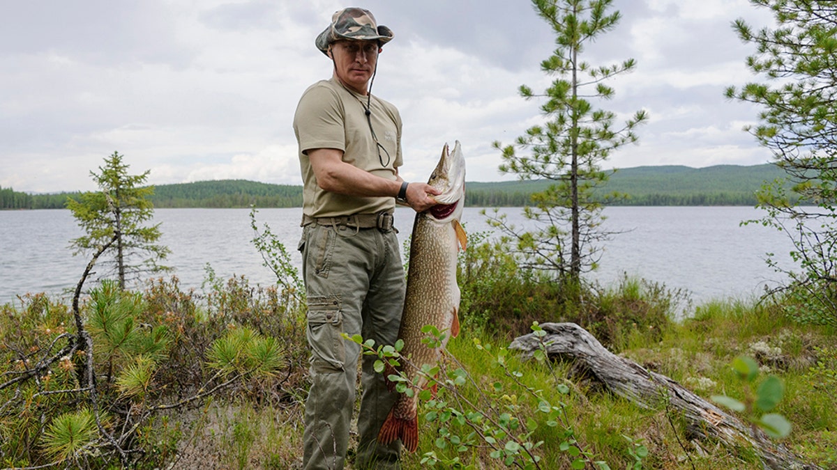 Russia's President Vladimir Putin poses for a picture as he fishes in the Krasnoyarsk territory in the Siberian Federal District July 20, 2013.