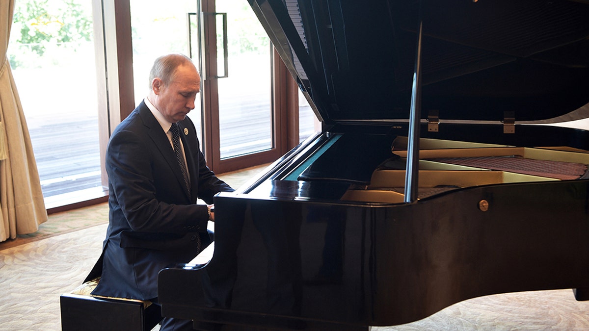 Russian President Vladimir Putin plays piano before his talks with Chinese President Xi Jinping prior to the opening ceremony of the Belt and Road Forum in Beijing, Sunday, May 14, 2017. (Alexei Nikolsky, Sputnik, Kremlin Pool Photo via AP)