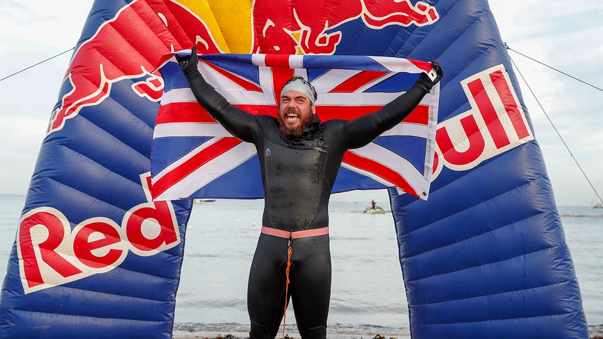 Ross Edgley of England celebrates finishing his 'Great British Swim', a historic nearly 2,000 mile swim around Great Britain. (Photo by Luke Walker/Getty Images for Red Bull)