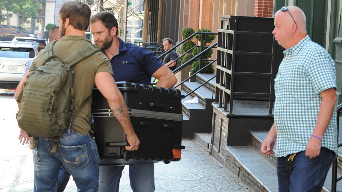 Taylor Swift being transported in a huge suitcase from her Tribeca apartment into her truck, in the trunk. A fleet of cars including two large cadillacs and three suv's arrive at Tailor Swift's apartment in Tribecca to move a large suitcase from apartment to truck. Almost a dozen of Taylor Swift security guards were present to move this package carefully as Taylor Swift remains to be unseen for a long time. Pictured: Taylor Swift Ref: SPL1539678 170717 NON-EXCLUSIVE Picture by: SplashNews.com Splash News and Pictures Los Angeles: 310-821-2666 New York: 212-619-2666 London: 0207 644 7656 Milan: 02 4399 8577 photodesk@splashnews.com World Rights