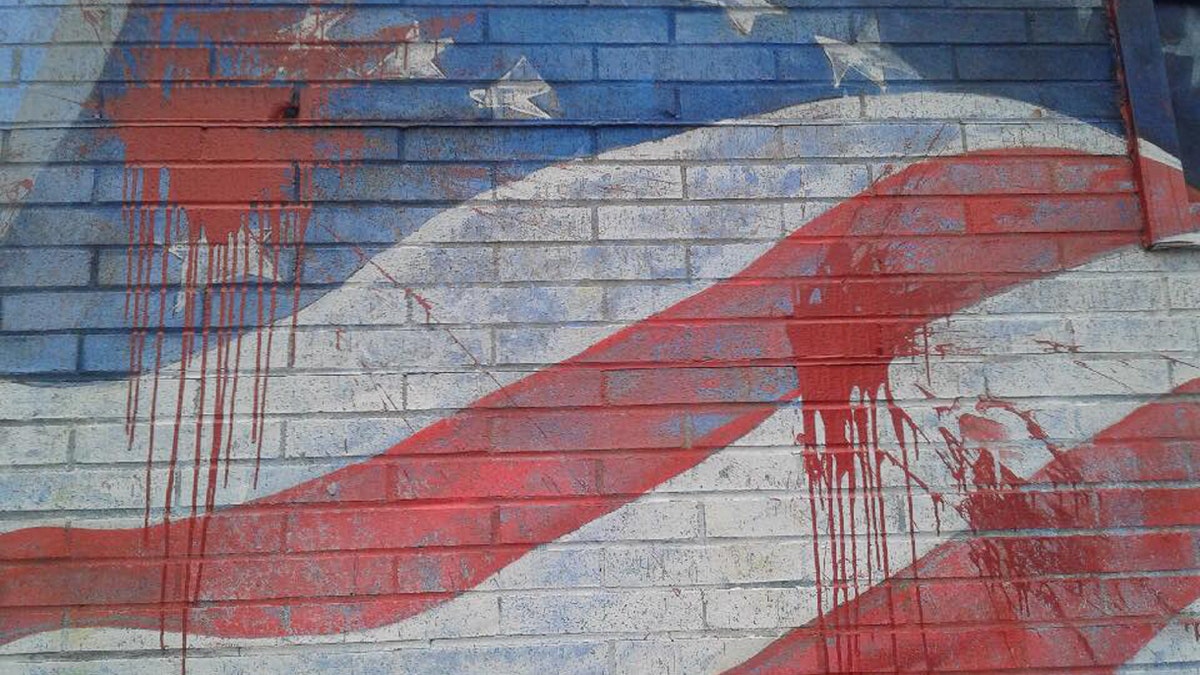 The American flag mural on the side of La Bella Pizza Bistro was vandalized Monday night. Police are investigating the situation.