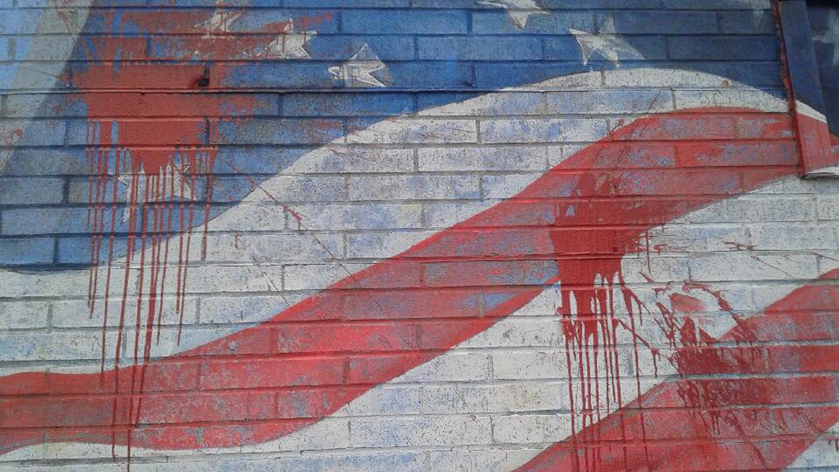 The American flag mural on the side of La Bella Pizza Bistro was vandalized Monday night. Police are investigating the situation.