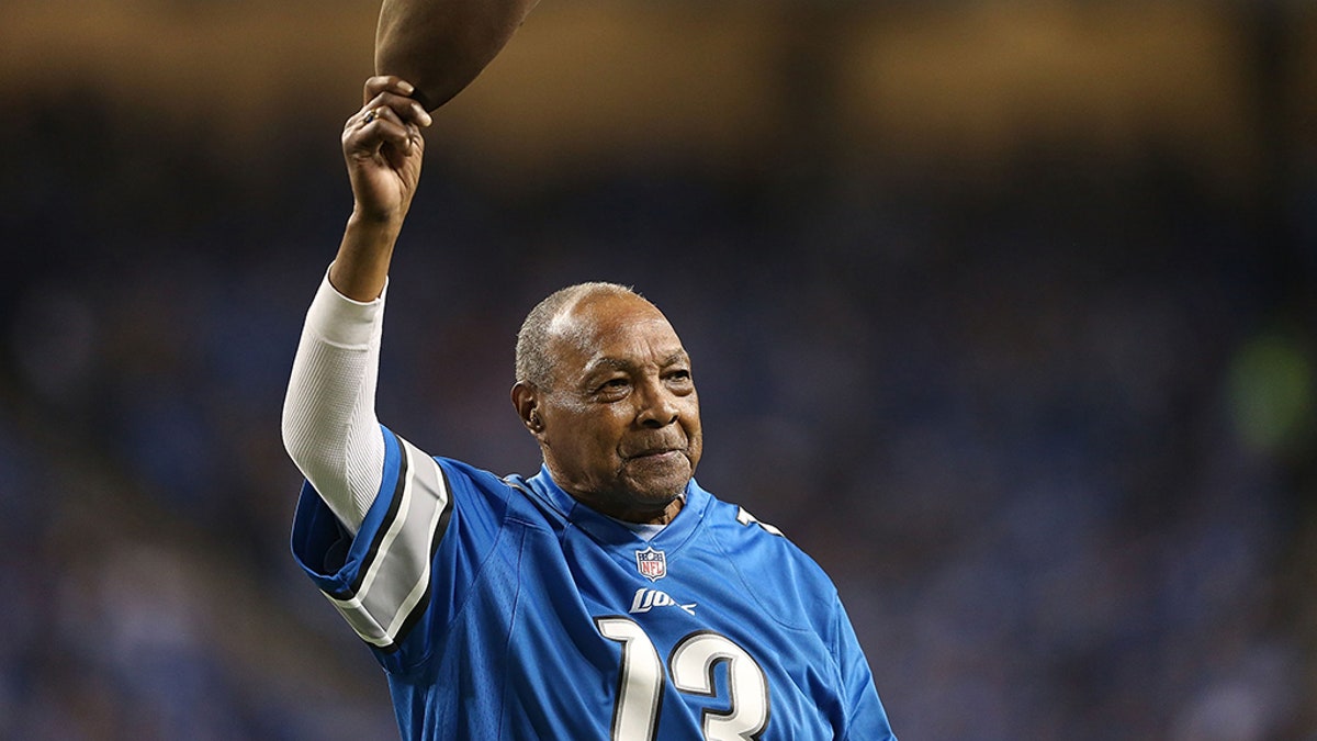 Former Detroit Lions player Wallace "Wally" Triplett waves to the fans during the game against the Baltimore Ravens at Ford Field on December 16, 2013 in Detroit, Michigan.