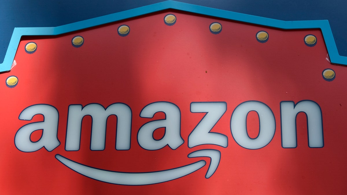 FILE - This Oct. 23, 2018, file photo shows an Amazon logo atop the Amazon Treasure Truck The Park DTLA office complex in downtown Los Angeles. Whether you've bought shoes at Zappos, picked up milk at Whole Foods or listened to an audiobook on Audible, you've been caught up in Amazon's growing web of businesses. And now, Amazon's sprawling empire will stretch even further. The company is expected to announce Tuesday, Nov. 13, that it will open two more bases outside of its Seattle headquarters: one in Crystal City in northern Virginia and the other in New York's Long Island City neighborhood. (AP Photo/Richard Vogel, File)