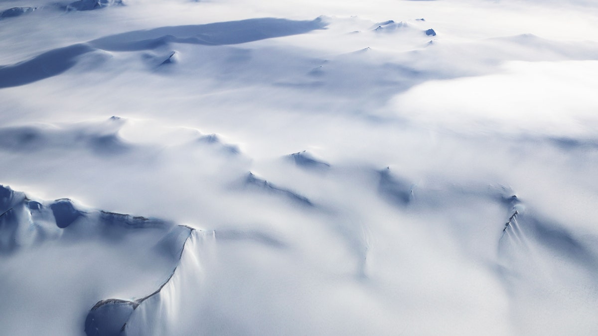 Mountain peaks are seen from NASA's Operation IceBridge research aircraft in the Antarctic Peninsula region, on November 4, 2017, above Antarctica.