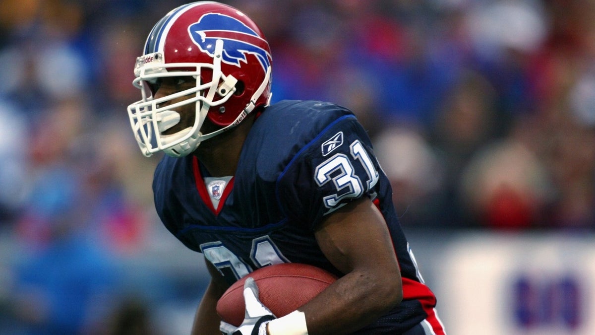 Former NFL player John "Charlie" Rogers Jr. turned himself in to police Monday and was charged with making terroristic threats, stalking and weapons offenses.