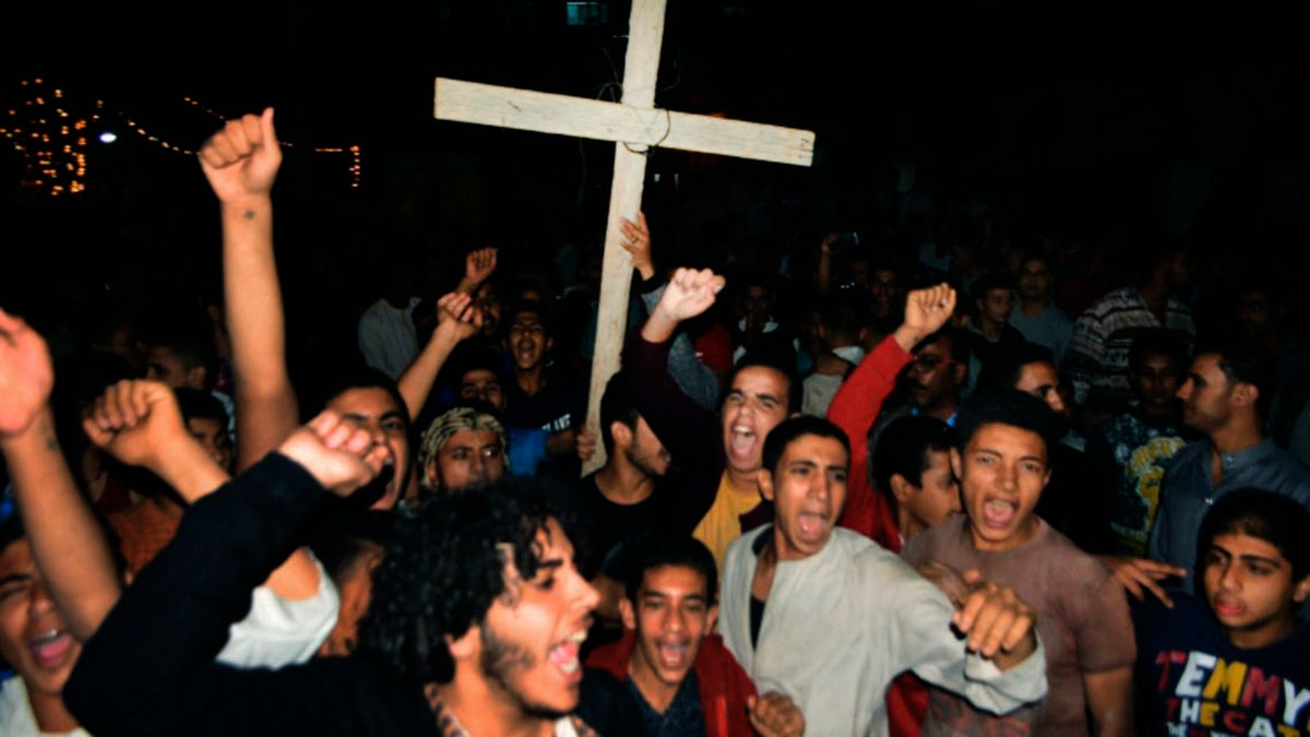 Coptic Christians chant slogans during a protest following an attack on a bus carrying Christian pilgrims on their way to a remote desert monastery, in Minya, Egypt, Friday, Nov. 2, 2018.