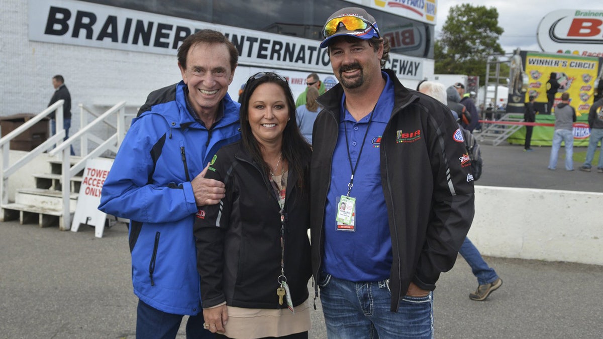 Jed Copham (r) with his wife Kristi (c) and Lucas Oil founder Forrest Lucas (l).