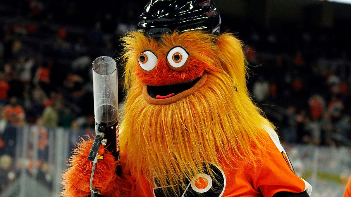 FILE - In this Sept. 24, 2018, file photo, the Philadelphia Flyers new mascot, Gritty, takes to the ice during the first intermission of the Flyers' preseason NHL hockey game against the Boston Bruins in Philadelphia. What better way to surprise a Philadelphia wedding party than with Gritty? CBS Philly reports newlyweds were shocked when the buck-eyed, 7-foot mascot for the NHL’s Flyers showed up Friday night, Nov. 23, 2018, and started dancing to laughs and applause.