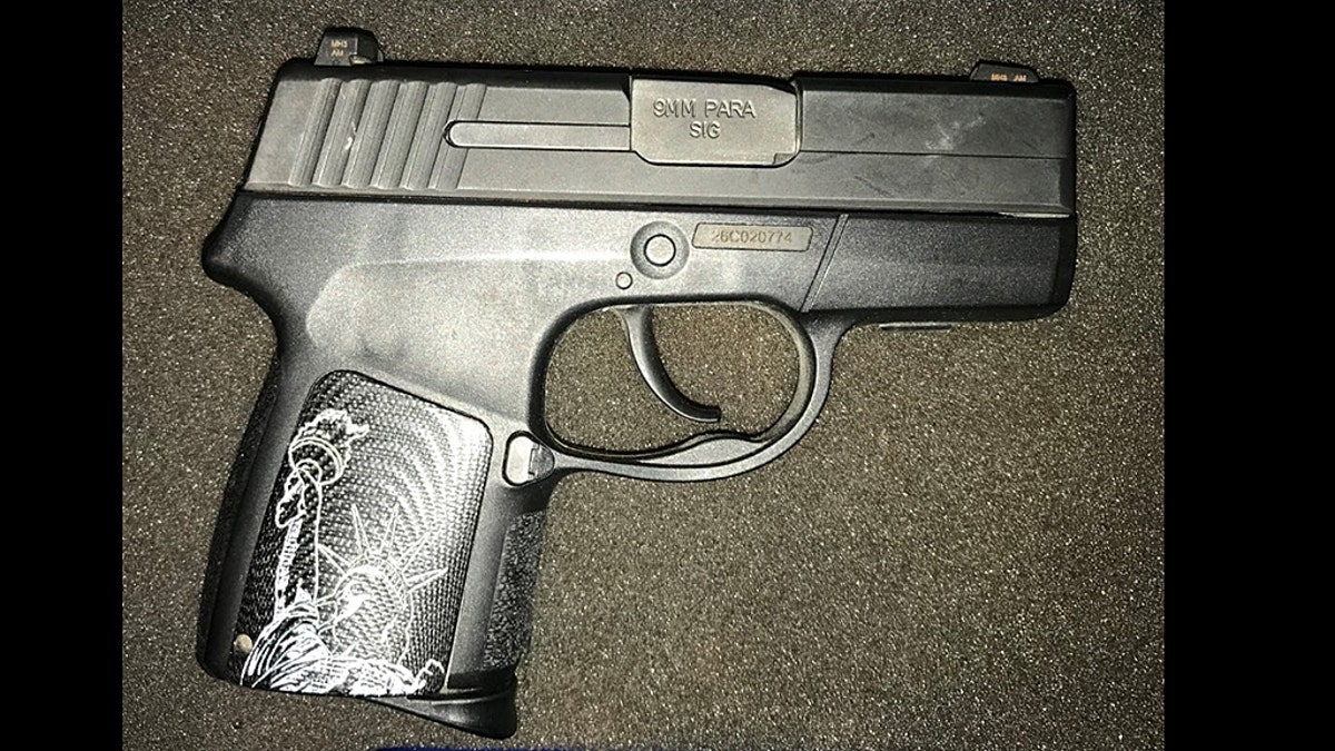 A woman was caught trying to carry a 9mm handgun with the Statue of Liberty on it through security at an airport in Virginia.