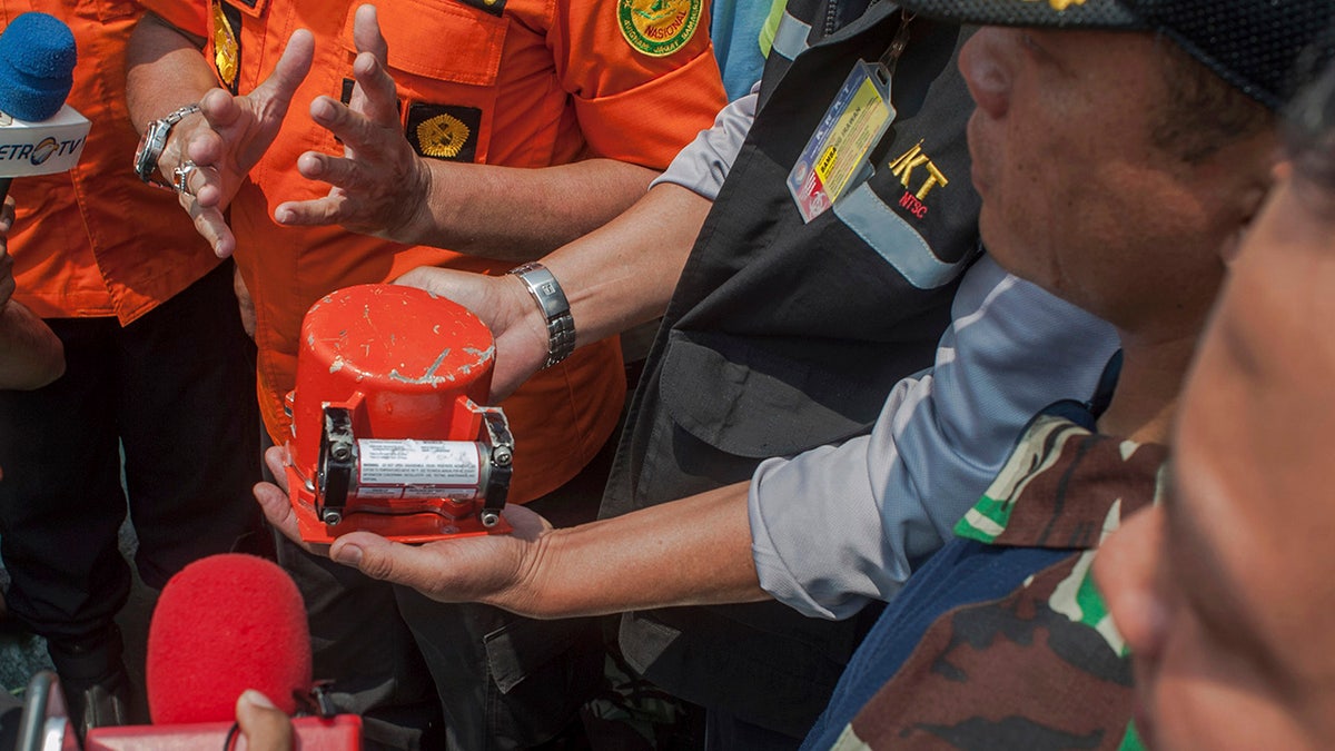 A member of National Transportation Safety Committee holds the flight data recorder from the crashed Lion Air jet on board of a research ship Baruna Jaya anchored in the waters of Tanjung Karawang, Indonesia on Thursday.
