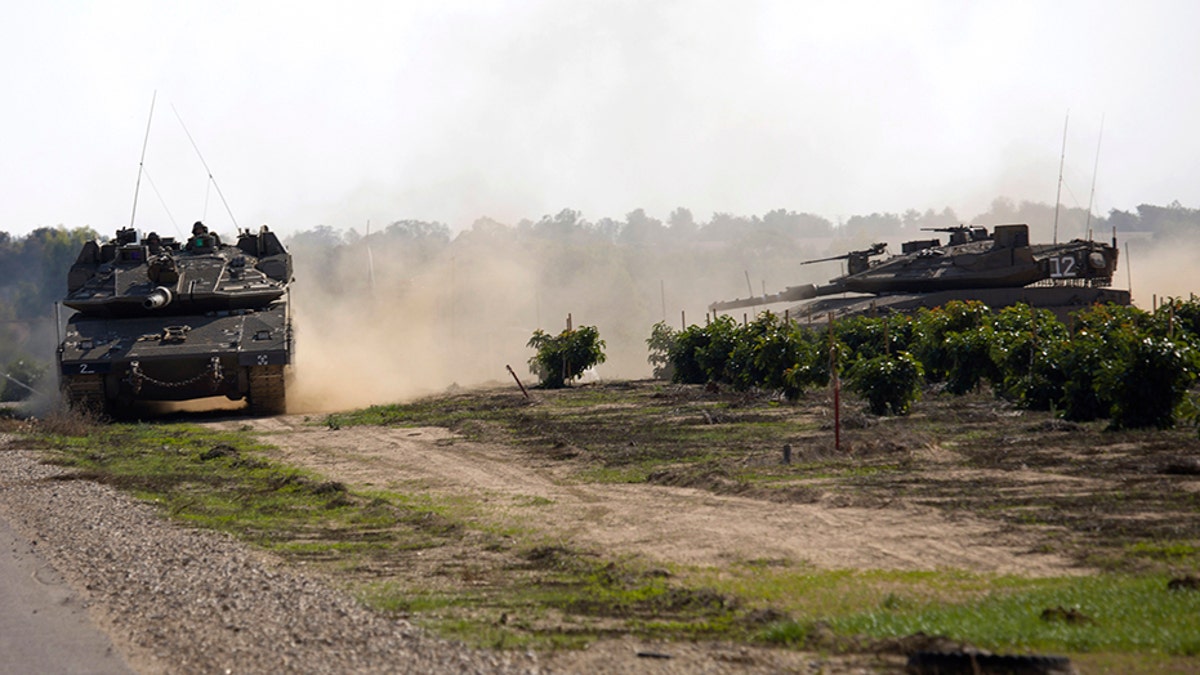Israeli tanks move near the Israel Gaza border on Tuesday.