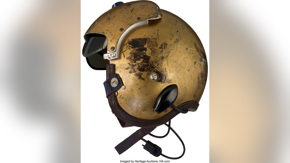 This undated photo provided by Heritage Auctions shows a helmet worn by John Glenn during the history-making flight, dubbed Project Bullet, in which the future astronaut set the transcontinental speed record in 1957. Artifacts owned by the late Neil Armstrong will be offered for sale by Dallas-based Heritage Auctions starting Thursday, Nov. 1, 2018, including pieces of a wing and propeller from the 1903 Wright Flyer the astronaut took with him to the moon in 1969. (Courtesy of Heritage Auctions via AP)