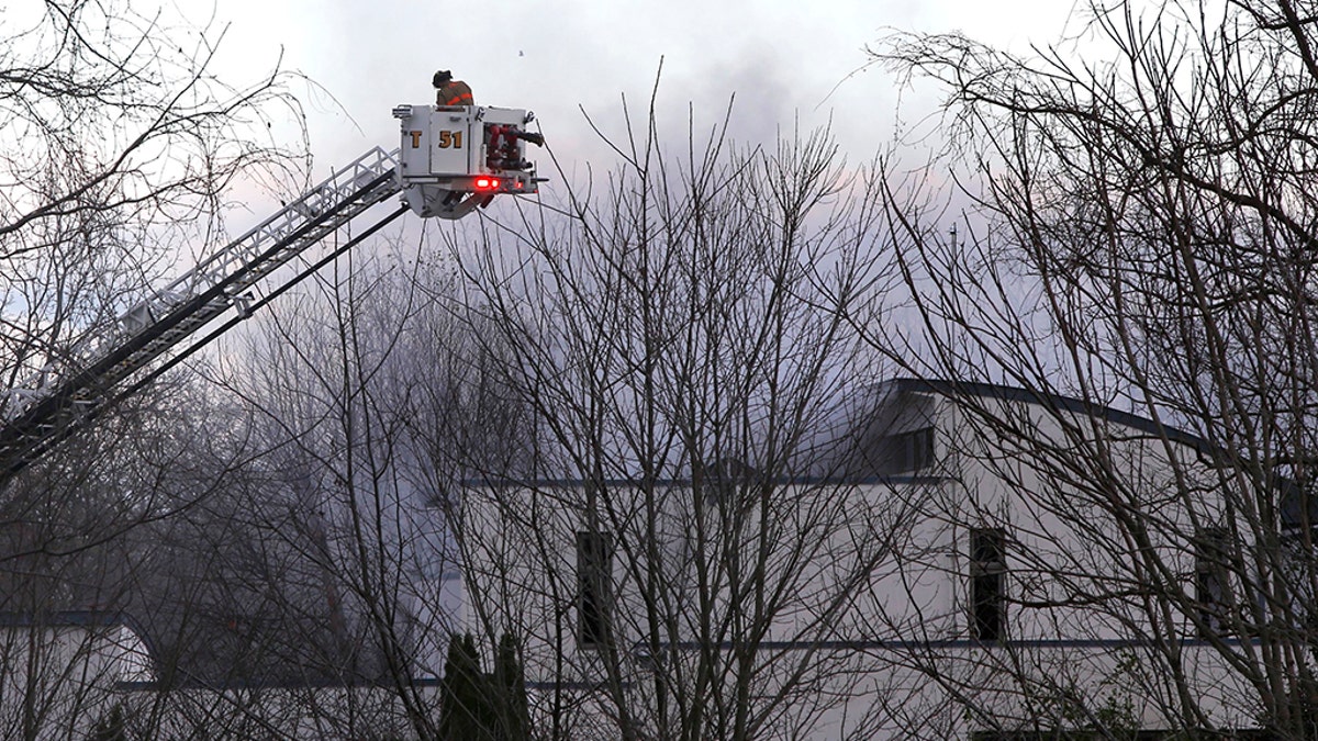 Authorities say two adults and two children were found dead at the scene of a burning mansion near the New Jersey shore.