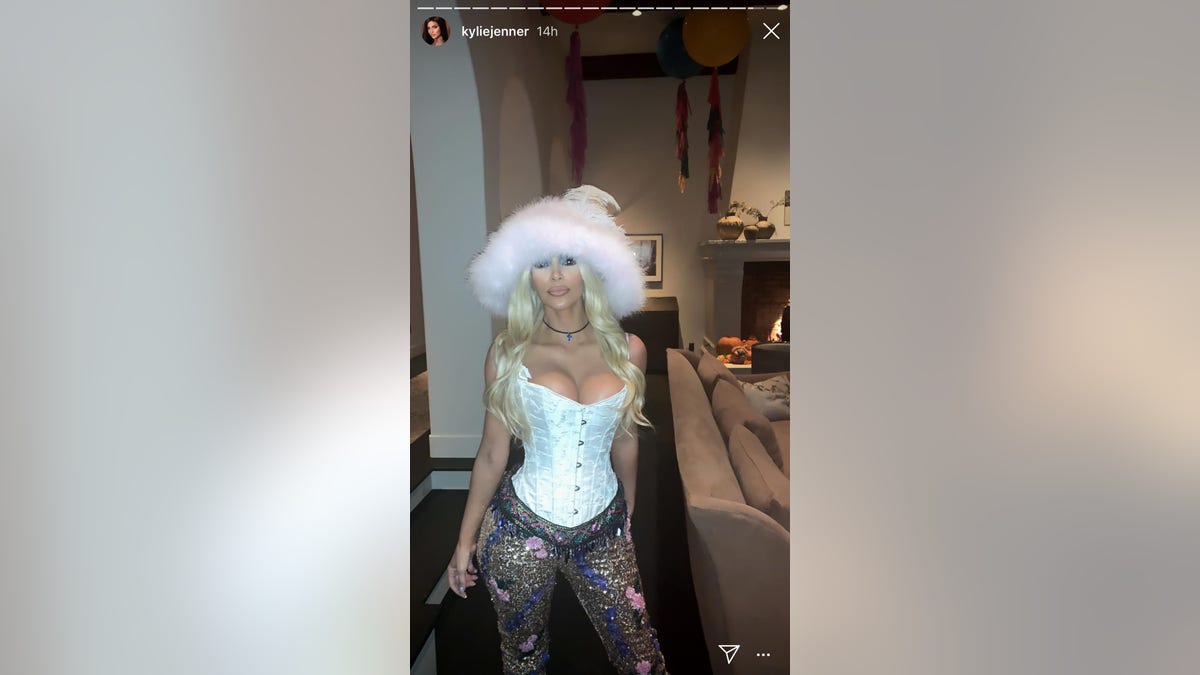 Kim Kardashian, dressed as Pamela Anderson, poses for sister Kylie Jenner's Instagram story. Kardashian is under fire for calling people the R-word after they didn't get her Halloween costume.