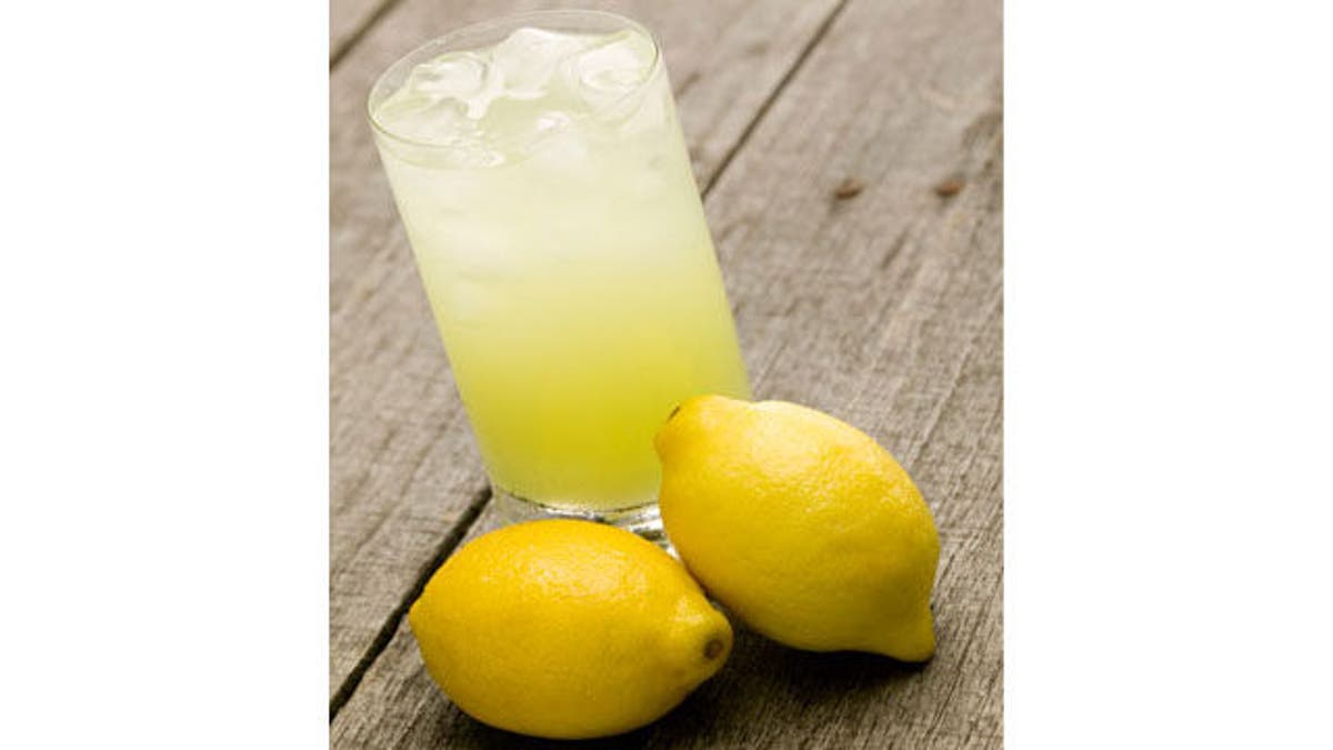 Glass of lemonade with lemons