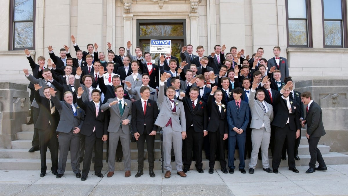 A group of Wisconsin high school boys stand on the steps outside the Sauk County Courthouse in Baraboo, Wisconsin.