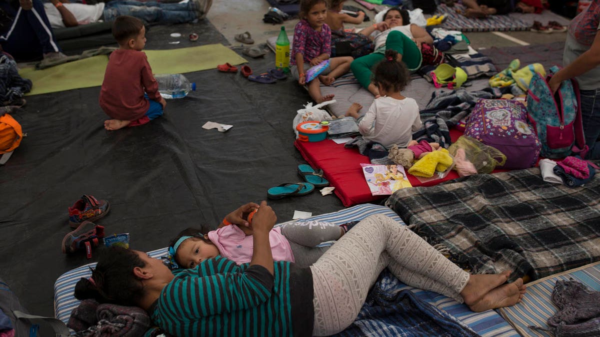 Honduran Migrant Glenia Cruz feeds her daughter Aisley, at a shelter in Tijuana, Mexico, Monday, Nov. 19, 2018.