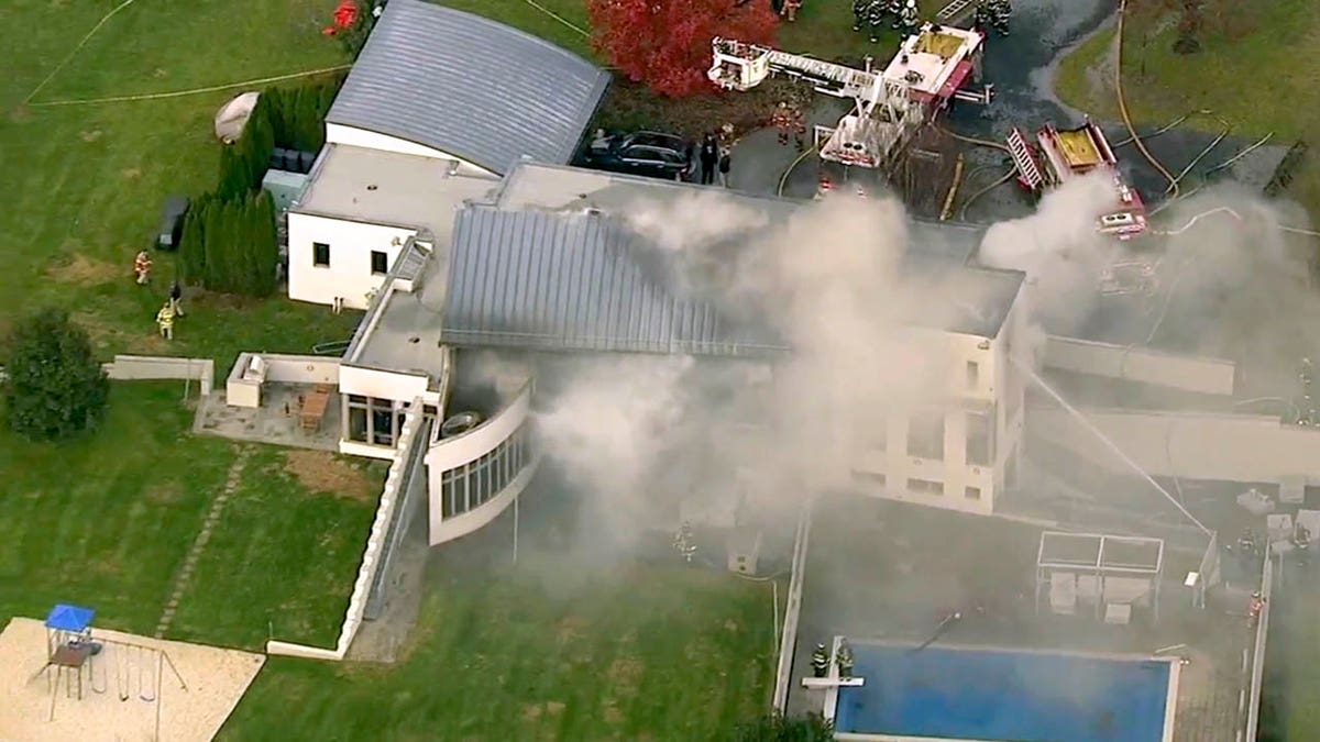 In this image made from a video provided by WABC firefighters battle a fatal fire on Tuesday, Nov. 20, 2018, in Colts Neck, N.J.