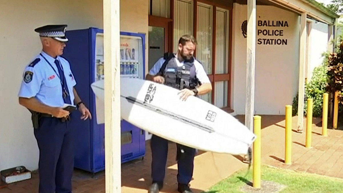 A man has used his surfboard to fend off a shark that bit him on his calf off an Australian beach two days after a fatal attack on the Great Barrier Reef.