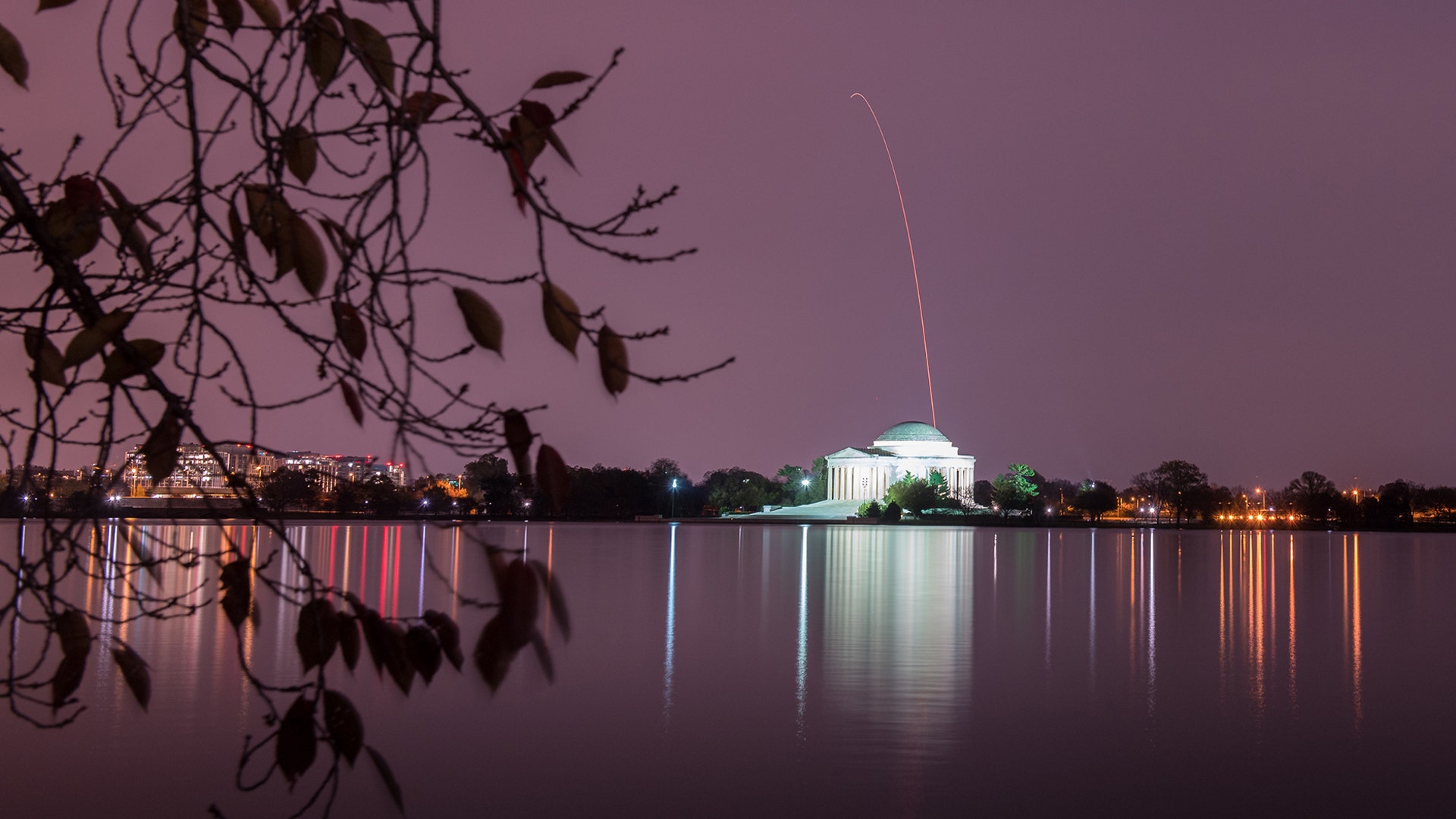 The Northrop Grumman Antares rocket with the Cygnus resupply spacecraft onboard is seen above the Thomas Jefferson Memorial in Washington, DC, after launching from the NASA Wallops Flight Facility in Virginia, Nov. 17, 2018 