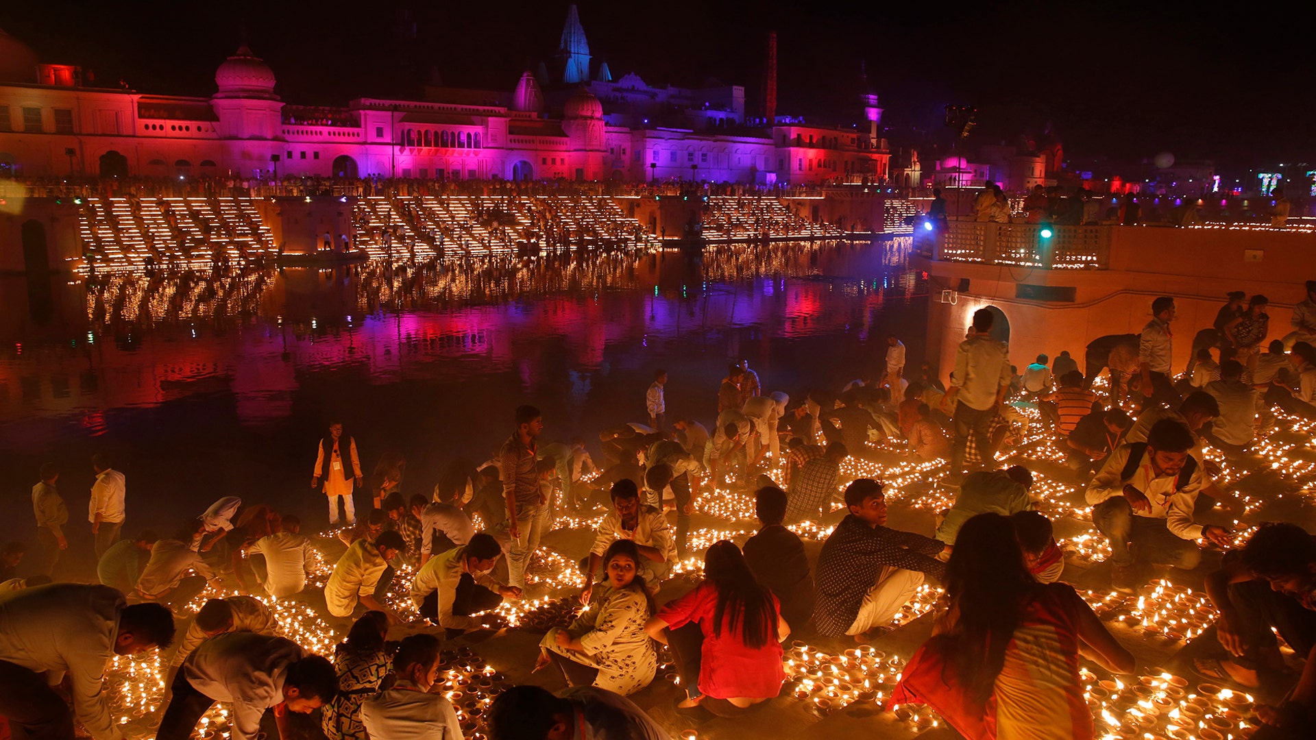 Devotees light earthen lamps on the banks of the River Sarayu as part of Diwali celebrations in Ayodhya, India, India, November 6, 2018. 