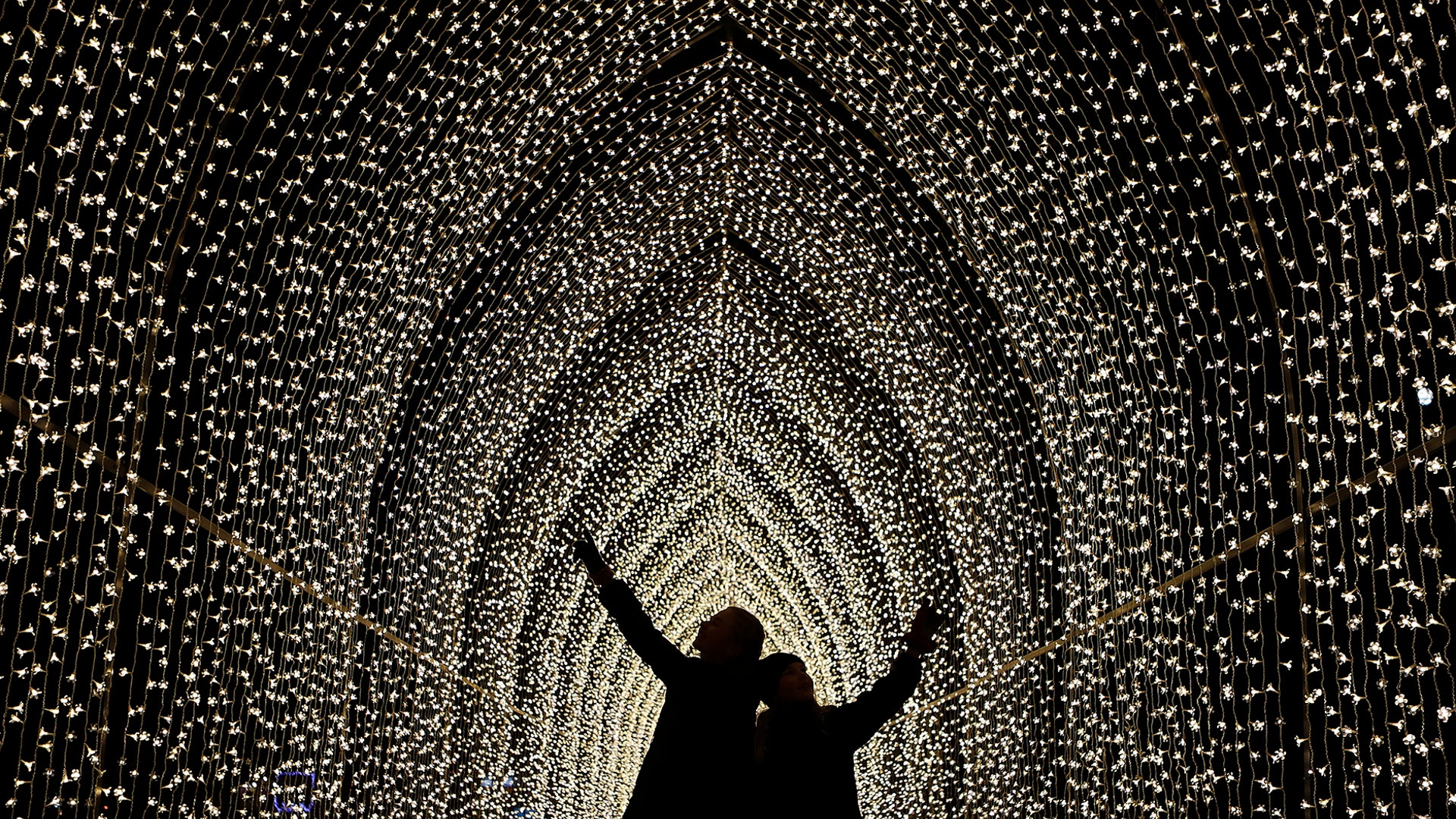 Children walk through the Cathedral of Light as part of the illuminated trail through Kew Gardens magnificent after-dark landscape, lit up by over one million twinkling lights in London, Nov. 21, 2018. 