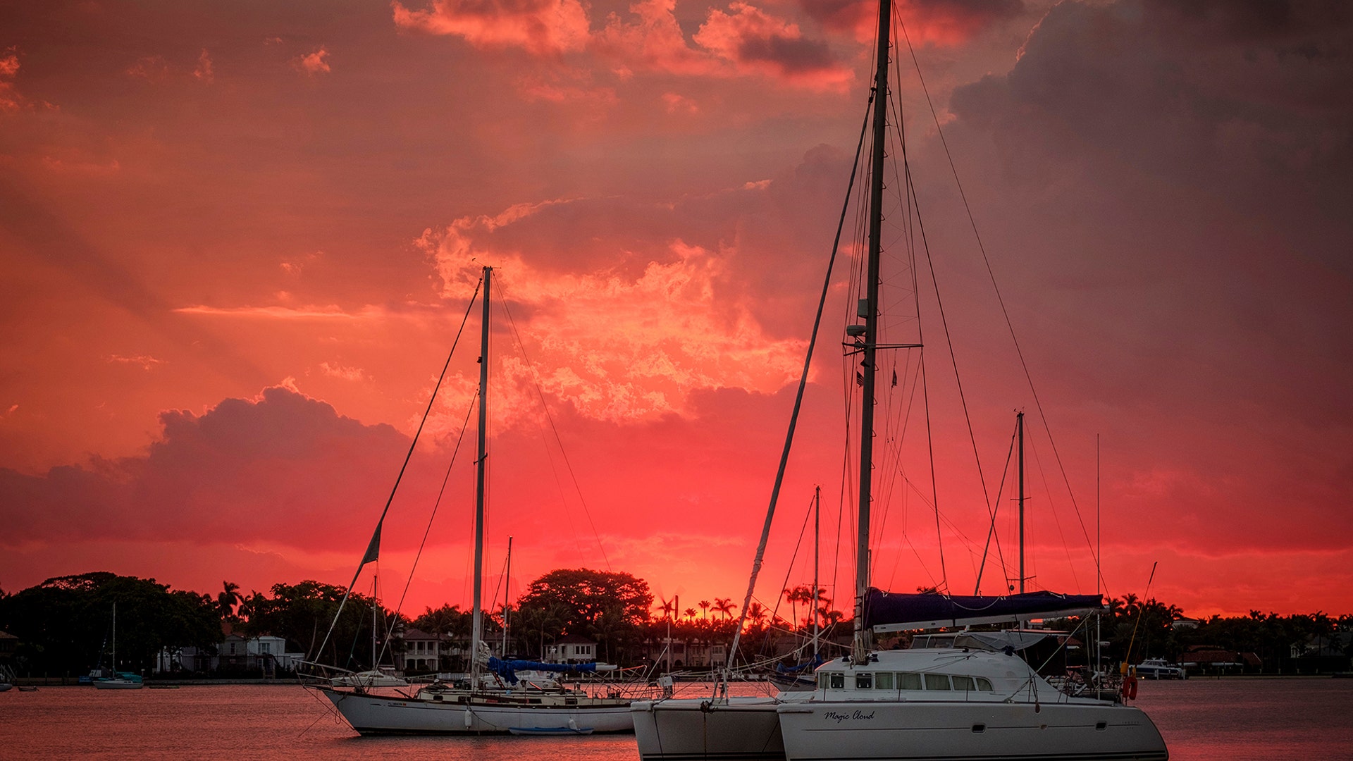 The sun peaks over the horizon and lights up the sky along the West Palm Beach, Florida waterfront, Nov. 22, 2018. 