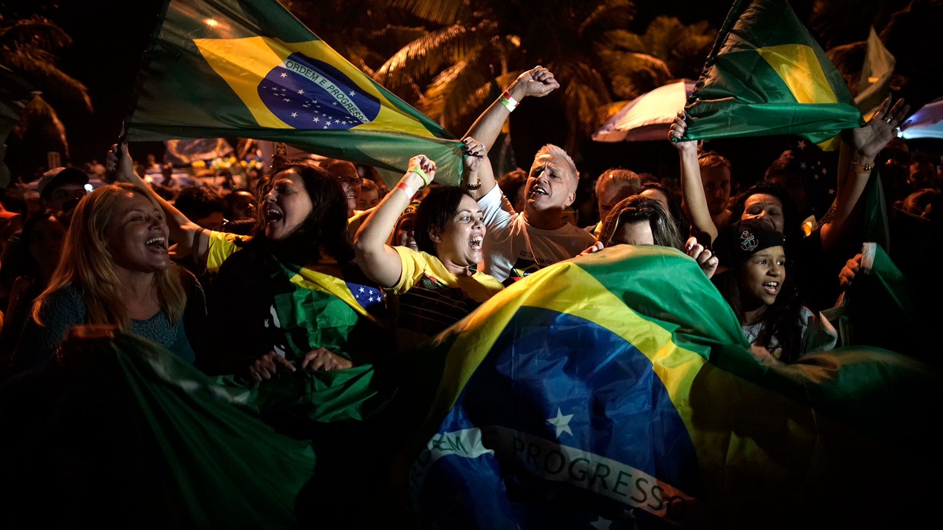 Supporters of Jair Bolsonaro celebrate in front of his residence in Rio de Janeiro, Brazil, Oct. 28, 2018. 
