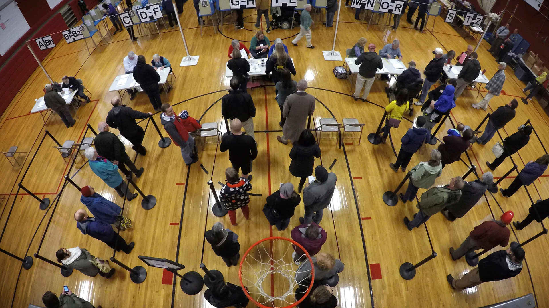 Voters wait in line in the gymnasium at Brunswick Junior High School to receive their ballots for the mid-term election, in Brunswick, Maine, November 6, 2018. 