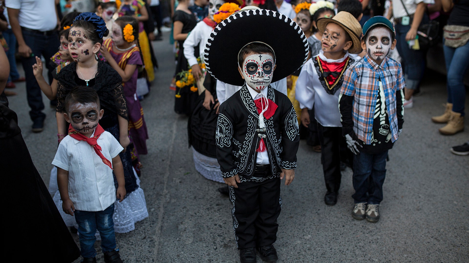 Children in costume gather for the start of a parade marking Day of the Dead in Juchitan, Mexico, Oct. 31, 2018.