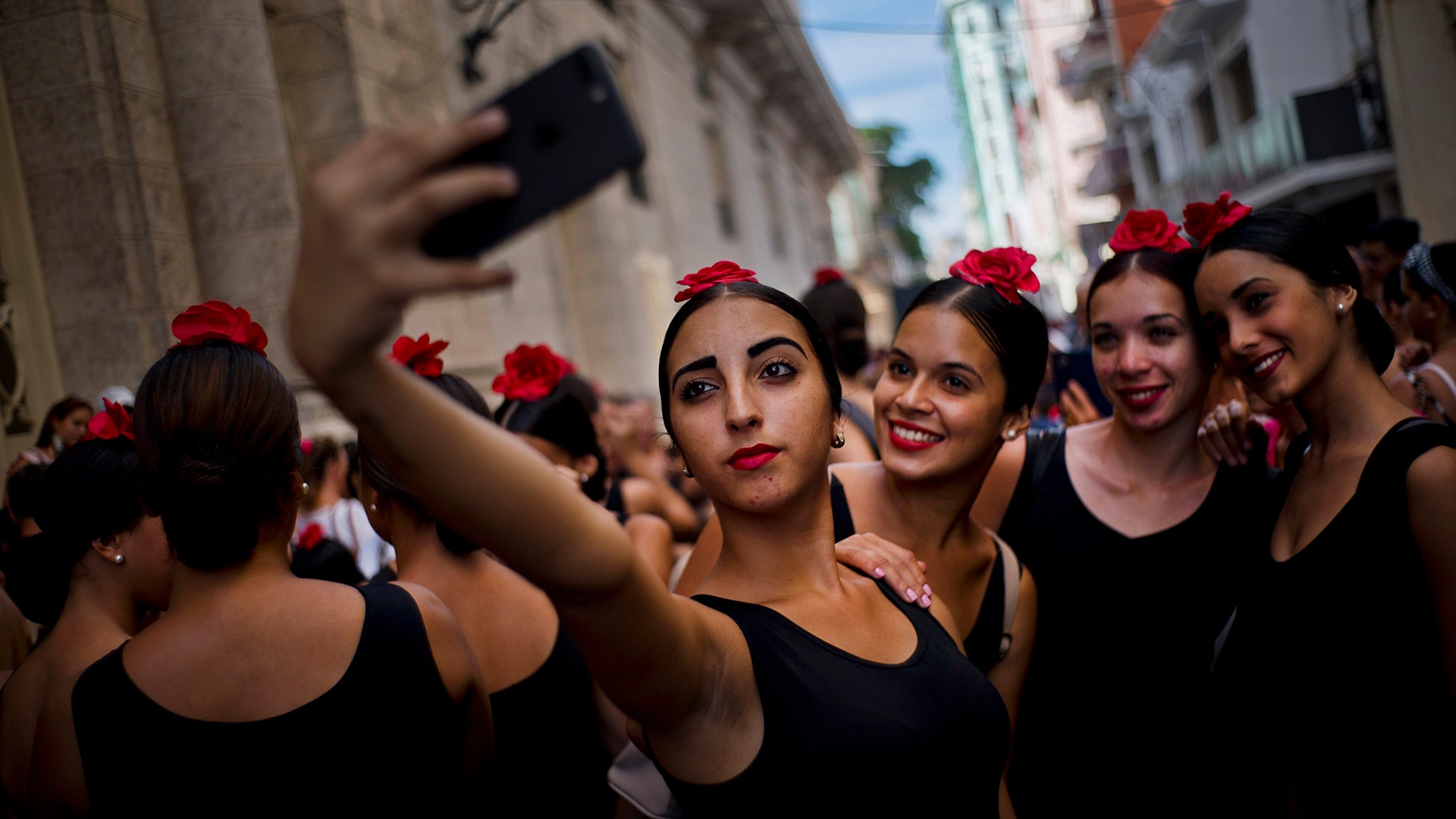 Young flamenco dancers take a selfie before performing in the street during the 26th International Ballet Festival in Havana, Cuba, November. 4, 2018.